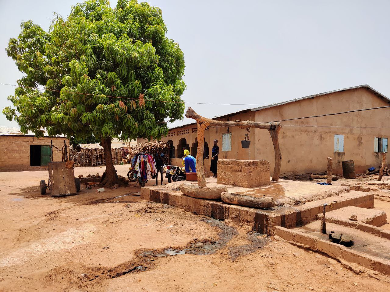 A village courtyard with a public well in Koina, The Gambia
