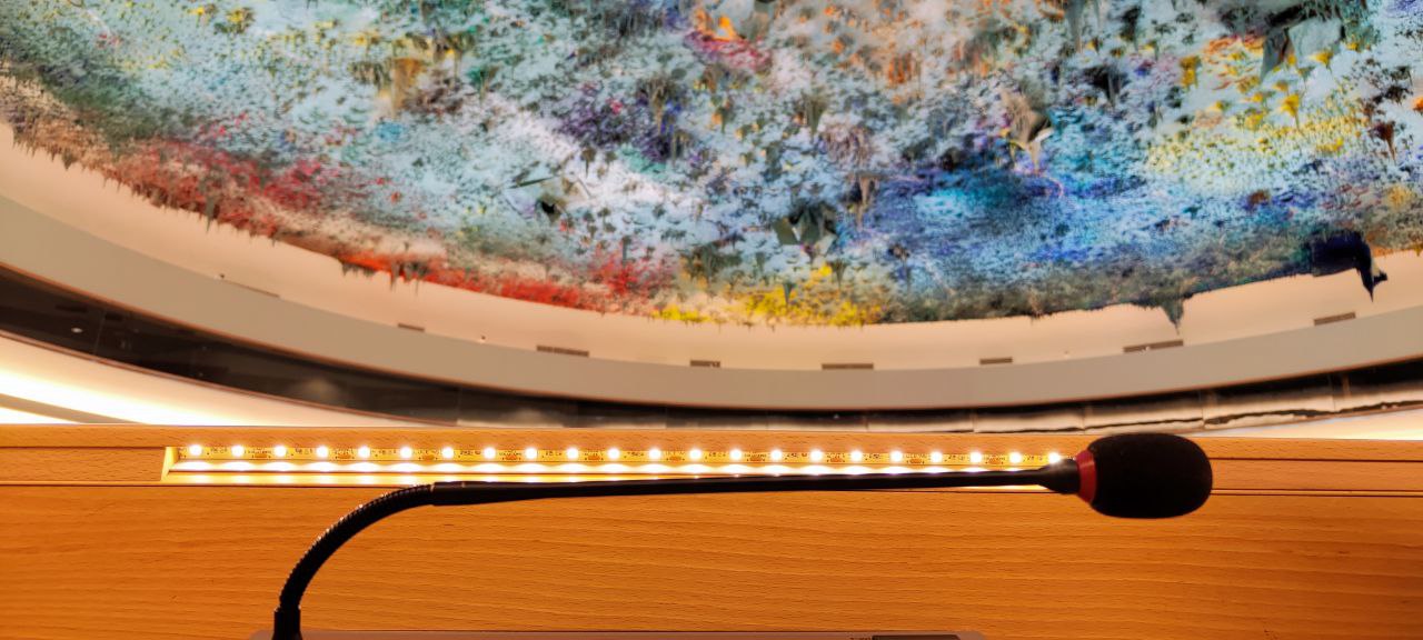 The painted dome ceiling and a delegate microphone in the UN Human Rights Council chamber, Geneva