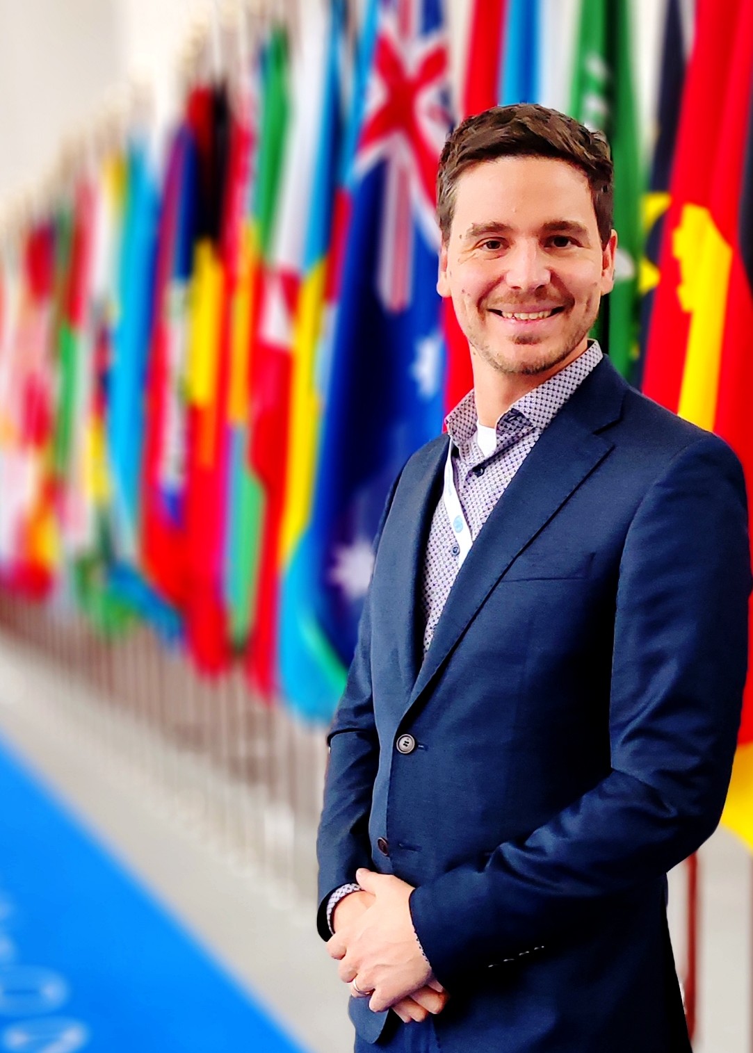 Headshot Picture at the the ILO in Geneva with flags